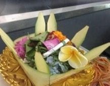 Offerings of flower petals and a cigarette